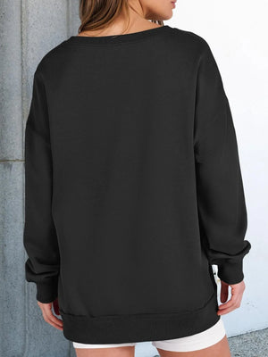 Person wearing a black sweatshirt with a plain background