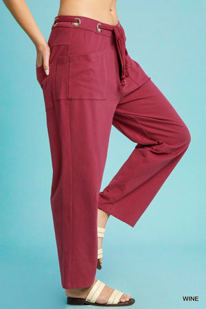 Maroon wide-leg pants with a belt on a blue background