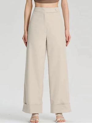 Beige wide-leg pants worn by a person on a light gray background