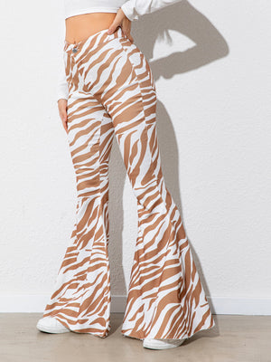 Zebra print flared pants worn by a person against a white background