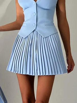Light blue pleated dress with a fitted bodice on a plain background