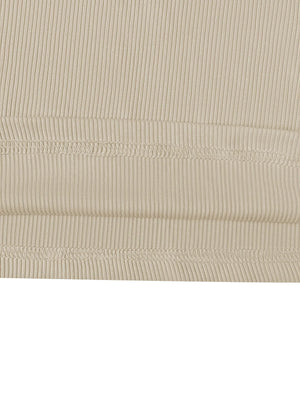Close-up of beige ribbed fabric with visible stitching on a white background
