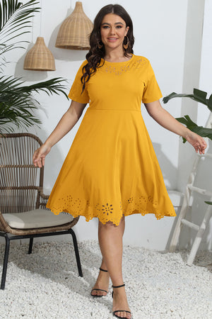 Woman wearing a yellow dress in an outdoor setting with plants and furniture.
