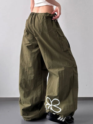 Person wearing olive green cargo pants on a plain background