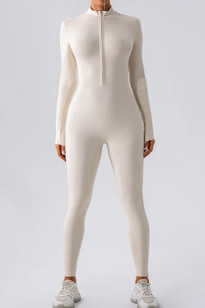 Person wearing a beige bodysuit on a light gray background
