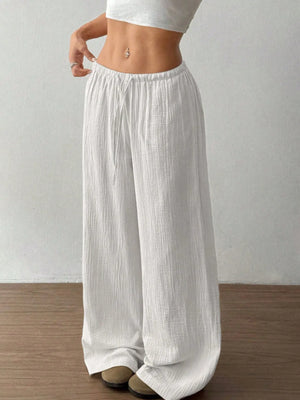 White wide-leg pants worn by a person on a plain background
