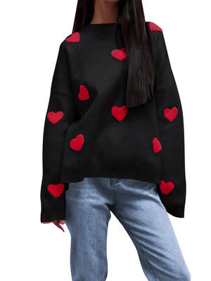 Black sweater with red heart patterns worn by a person on a white background