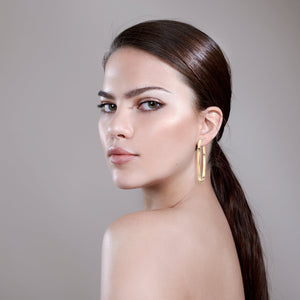 Woman wearing 2.5" Isla Hoops in her left ear