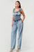Model showing pocket of Chambray Charm Ruffled Jumpsuit