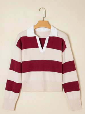 Beige and burgundy striped sweater on a hanger against a beige background