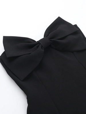 Black bow detail on a garment against a white background