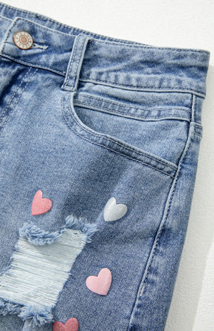 Close up view of front pockets on Distressed Raw Hem Heart Denim Skirt