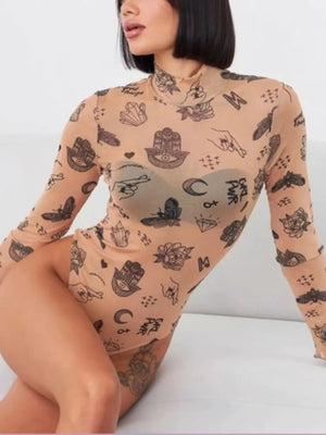 Person wearing a beige bodysuit with black tattoo-like patterns on a white background