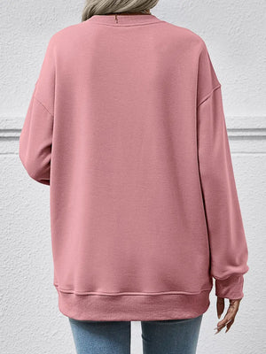 Pink sweatshirt worn by a person on a light gray background