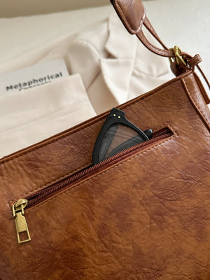 A view of the side pocket on brown PU Leather Adjustable Strap Crossbody Bag with Pouch