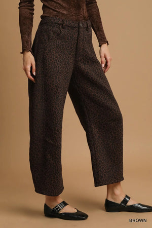 Brown patterned pants worn by a person on a beige background