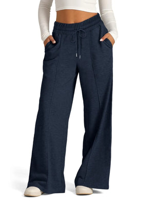 Navy blue wide-leg pants worn by a person on a white background