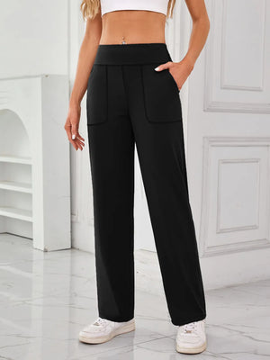 Person wearing black high-waisted pants with pockets in a minimalistic setting