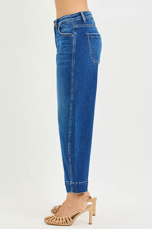 Blue jeans worn by a person on a white background