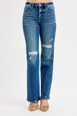 Blue jeans with distressed details on a white background