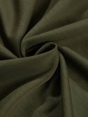 Close-up of dark green fabric with folds