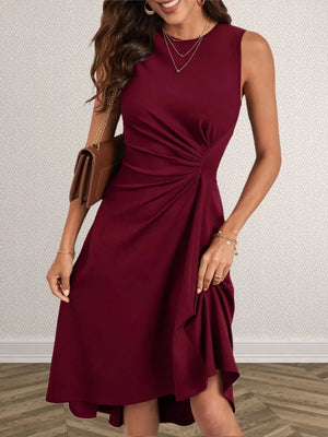 Woman wearing a burgundy dress with a neutral background