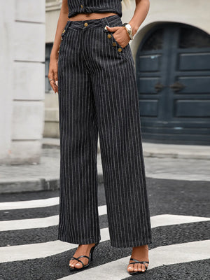 Person wearing pinstripe pants standing on a zebra crossing.