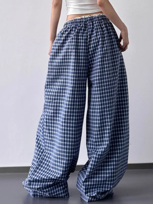 Blue and white checkered pants worn by a person on a plain background