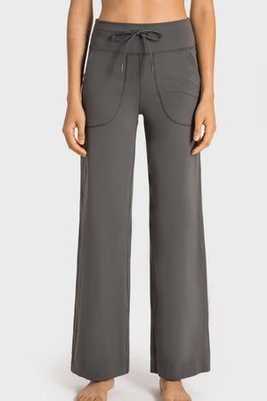 Gray wide-leg pants worn by a person on a white background
