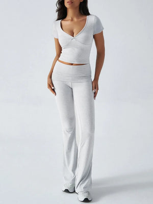 Woman wearing a white outfit on a plain background