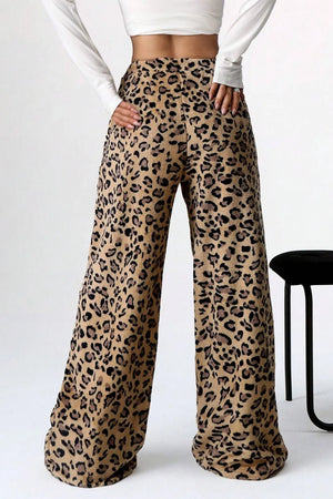Leopard print pants worn by a person on a white background