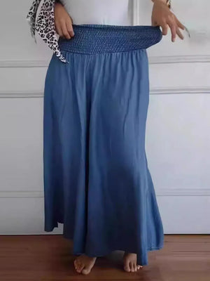 Person wearing a blue skirt with a white background