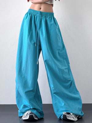 Turquoise wide-leg pants worn by a person on a plain background