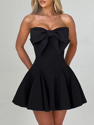 Black strapless dress with a large bow detail on a gray background