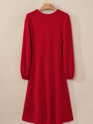Red dress with long sleeves on a beige background