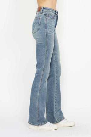 Blue jeans worn by a person on a white background