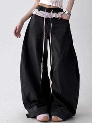 Black wide-leg pants with a white background