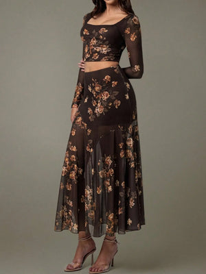 Woman wearing a black floral two-piece outfit on a gray background