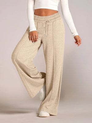 Beige wide-leg pants worn by a person on a plain background