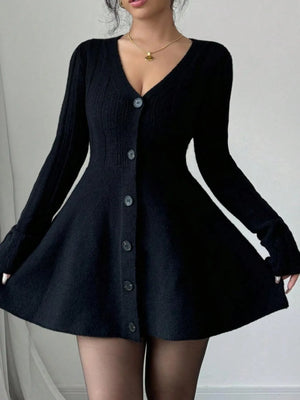 Black cardigan dress worn by a person on a plain background