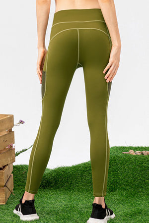 Person wearing green leggings on a grassy background