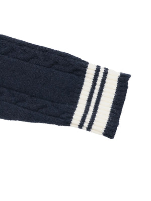 Navy blue cable knit glove with white stripe on a white background