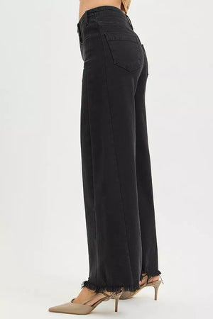 Black wide-leg pants worn by a person on a white background
