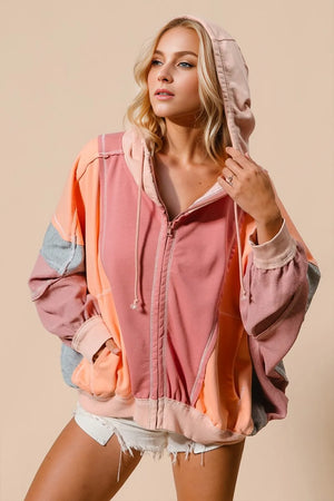 Woman wearing a colorful jacket with a neutral background