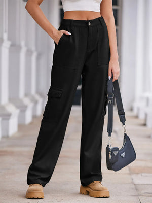Person wearing black cargo pants with a white top and tan shoes, holding a blue Prada handbag.