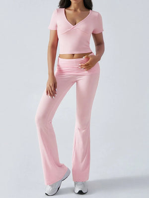 Person wearing a pink outfit on a light gray background