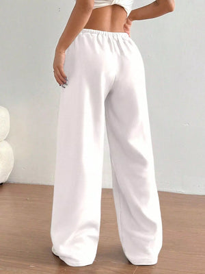 White wide-leg pants worn by a person on a plain background