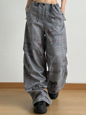 Plaid pants with text pattern worn by a person on a plain background