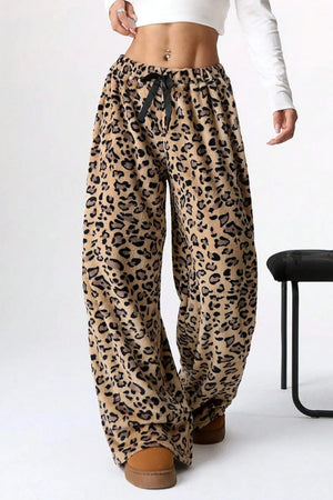 Leopard print pants worn by a person on a white background