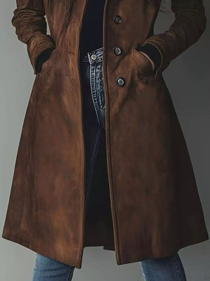 Brown leather coat worn by a person on a plain background